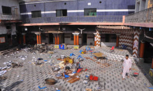 A member of the Hindu community walks inside the temple that was attacked on Saturday night, in Larkana, March 16, 2014.