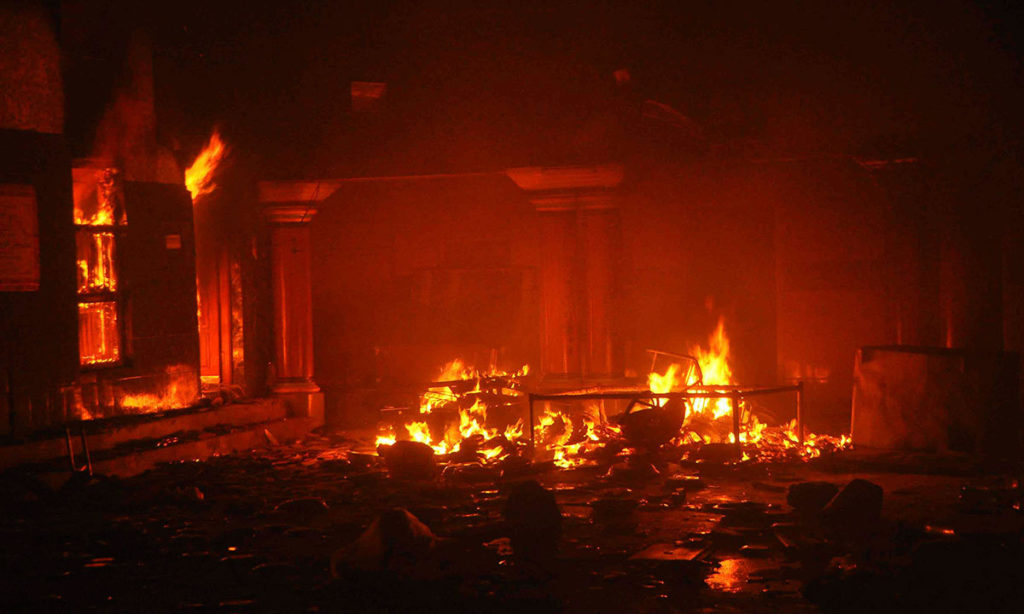 The temple burns after it was attacked in Larkana, Sindh Pakistan March 15, 2014.